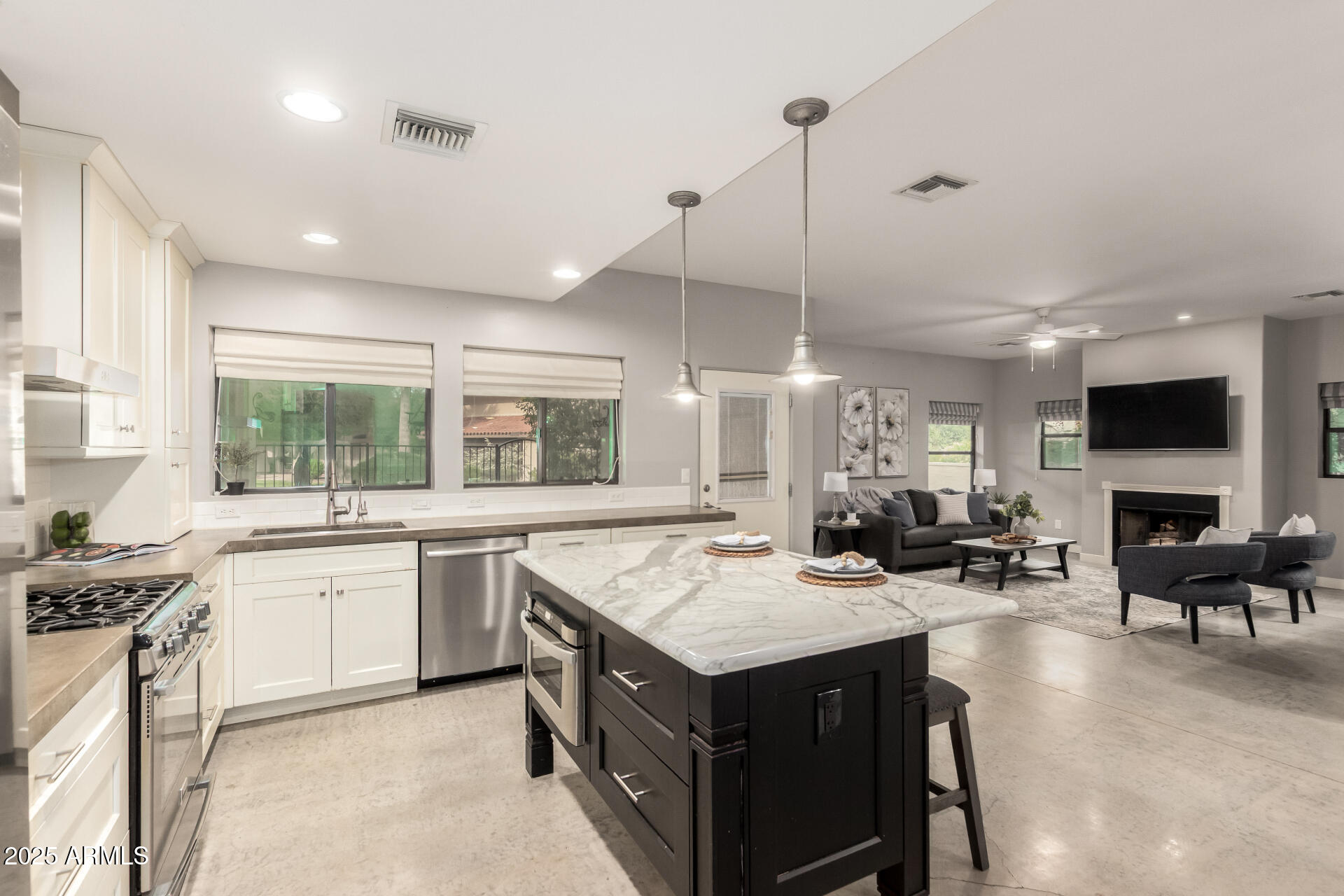 943 East Kortsen Road, Unit 10 Casa Grande, AZ 85122 - Photo 13 of 35 a kitchen with a stove a sink a microwave a dining table and chairs