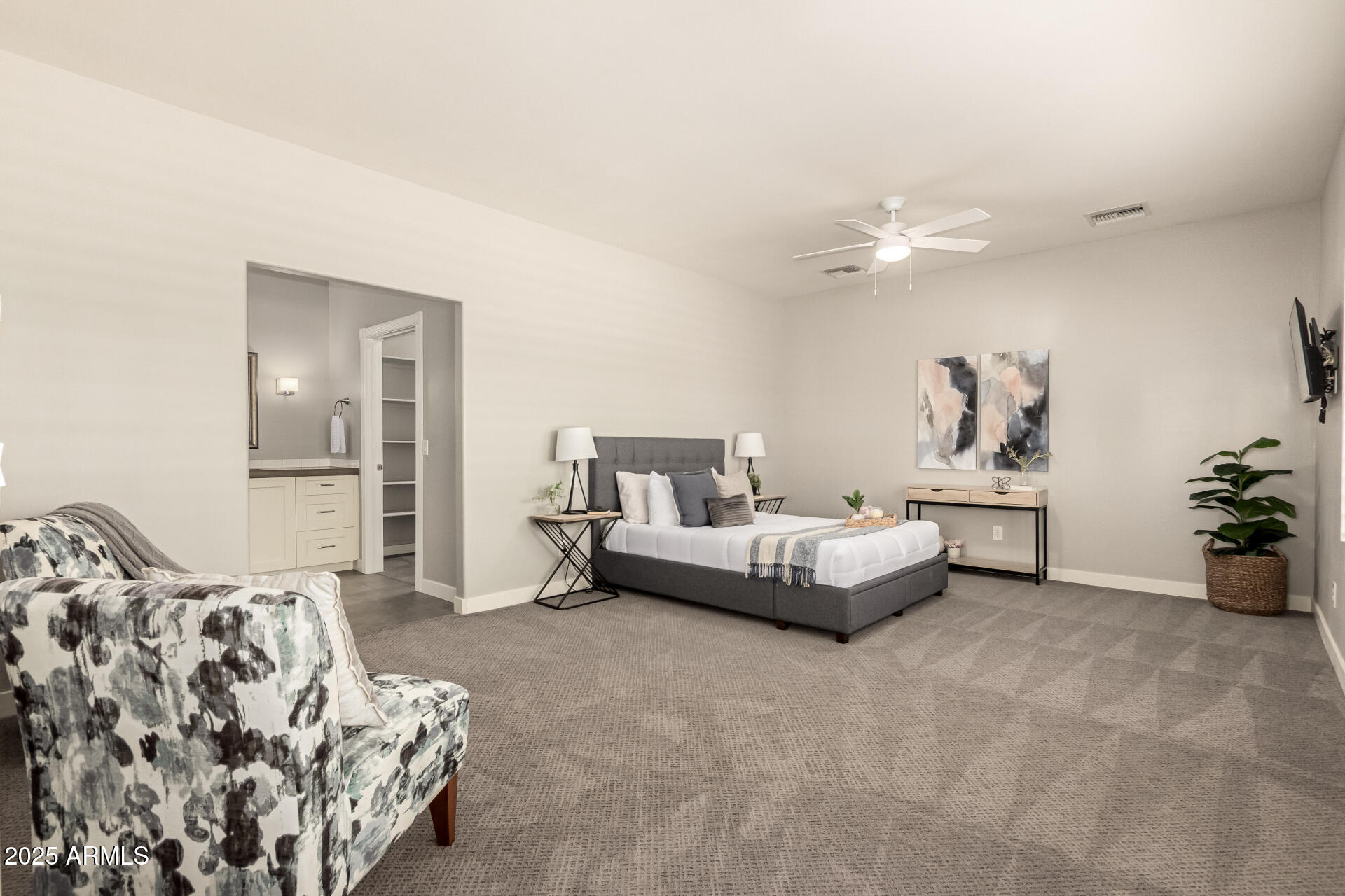 943 East Kortsen Road, Unit 10 Casa Grande, AZ 85122 - Photo 15 of 35 a spacious bedroom with a bed and a chandelier