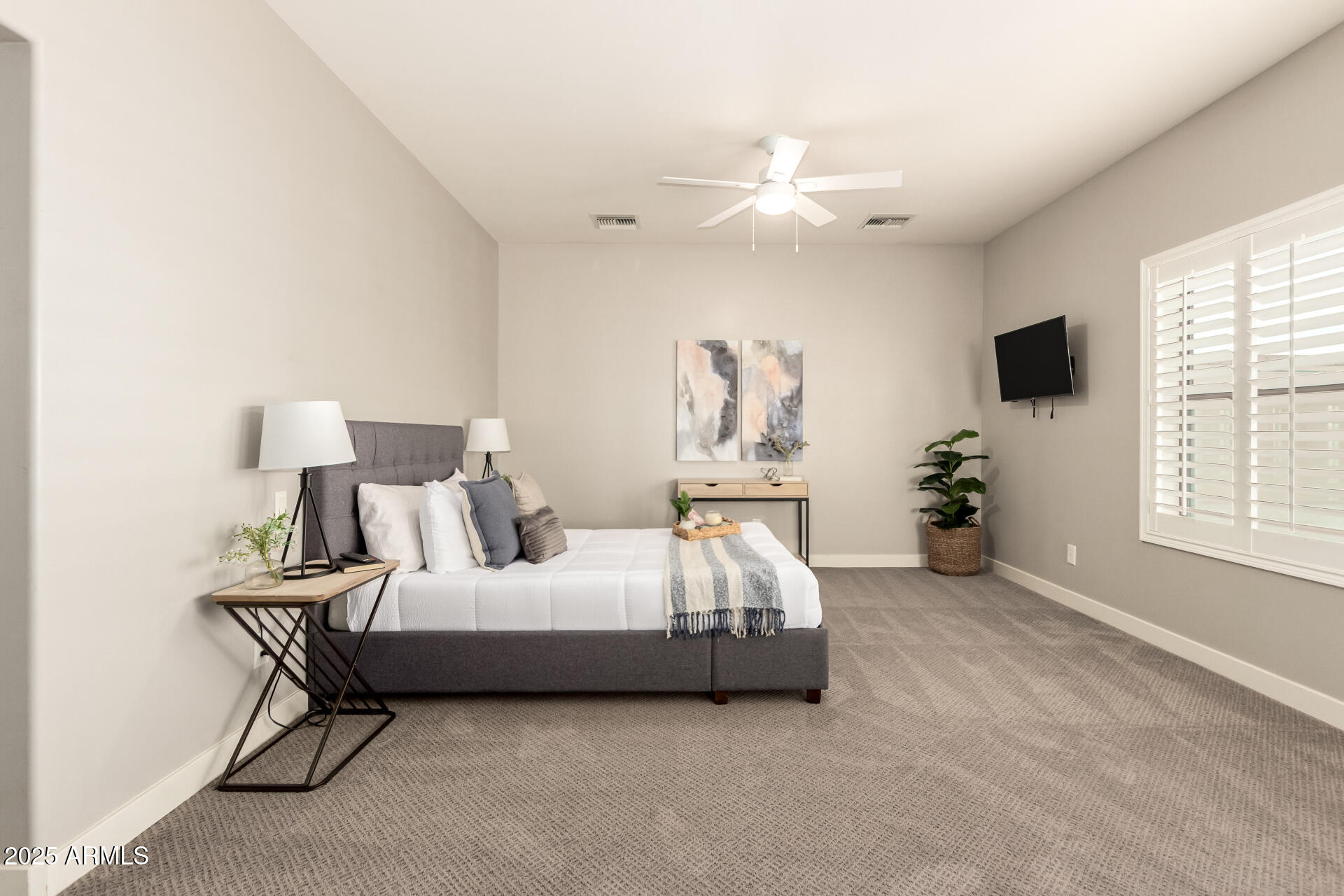 943 East Kortsen Road, Unit 10 Casa Grande, AZ 85122 - Photo 18 of 35 a spacious bedroom with a bed and a flat screen tv