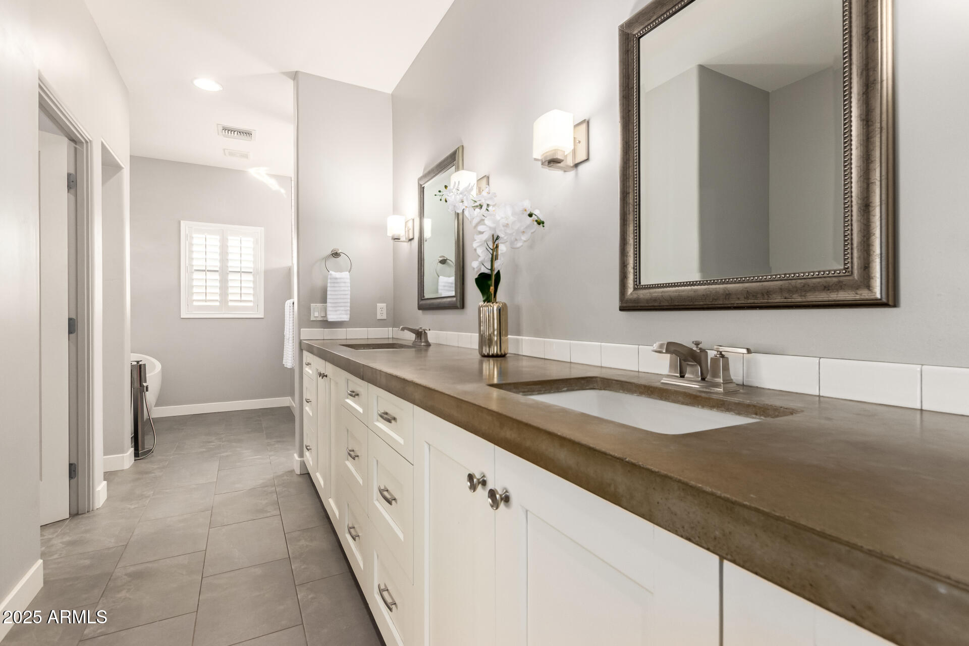 943 East Kortsen Road, Unit 10 Casa Grande, AZ 85122 - Photo 19 of 35 a bathroom with a double vanity sink and a mirror