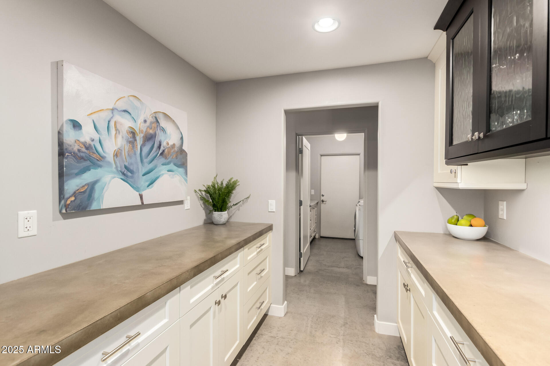 943 East Kortsen Road, Unit 10 Casa Grande, AZ 85122 - Photo 31 of 35 a hallway with a sink and a refrigerator