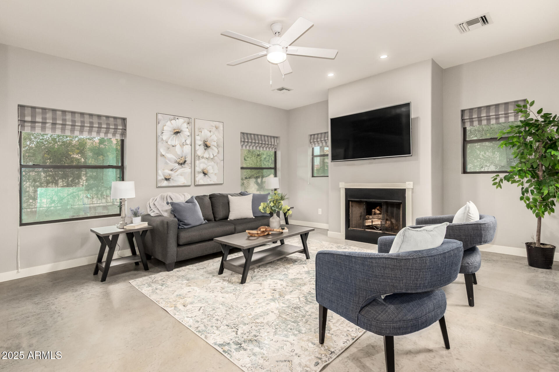 943 East Kortsen Road, Unit 10 Casa Grande, AZ 85122 - Photo 5 of 35 a living room with furniture a flat screen tv and a fireplace