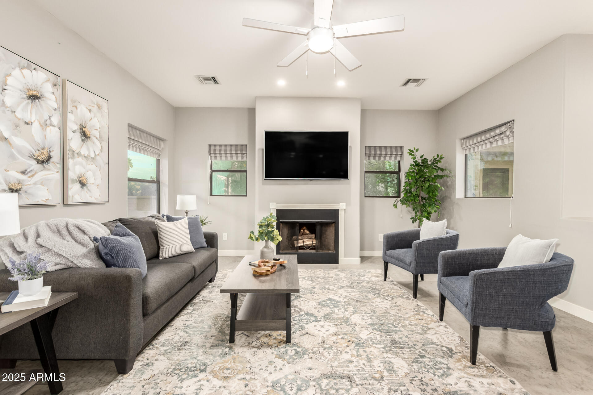 943 East Kortsen Road, Unit 10 Casa Grande, AZ 85122 - Photo 6 of 35 a living room with furniture a flat screen tv and a fireplace