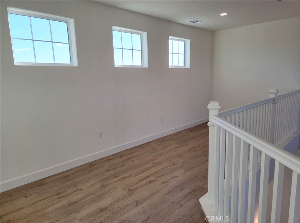 725 Manor Lane Paso Robles, CA 93446 - Photo 15 of 29 a view of an empty room with wooden floor and a window