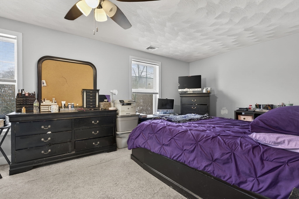 74 Linwood Street Lynn, MA 01905 - Photo 11 of 37 a bedroom with a bed and a flat screen tv