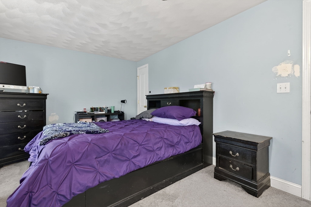 74 Linwood Street Lynn, MA 01905 - Photo 12 of 37 a bedroom with a bed and a tv