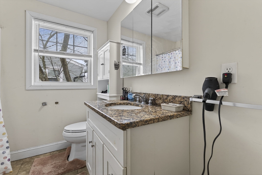 74 Linwood Street Lynn, MA 01905 - Photo 14 of 37 a bathroom with a granite countertop sink toilet and a mirror