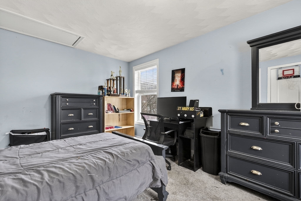 74 Linwood Street Lynn, MA 01905 - Photo 15 of 37 a bedroom with a bed and a television