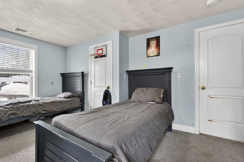 74 Linwood Street Lynn, MA 01905 - Photo 16 of 37 a bedroom with two beds and a fireplace