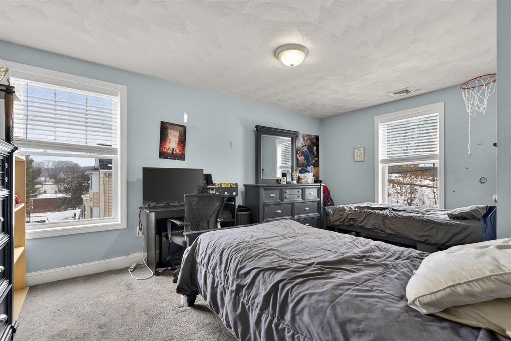 74 Linwood Street Lynn, MA 01905 - Photo 17 of 37 a bedroom with a bed and a flat screen tv