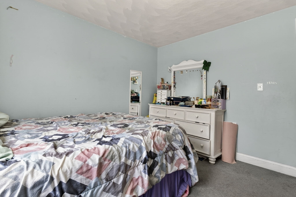 74 Linwood Street Lynn, MA 01905 - Photo 18 of 37 a bedroom with a bed and dresser