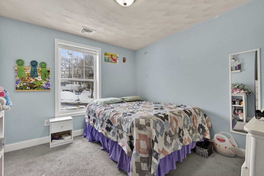 74 Linwood Street Lynn, MA 01905 - Photo 19 of 37 a bedroom with a bed and a window