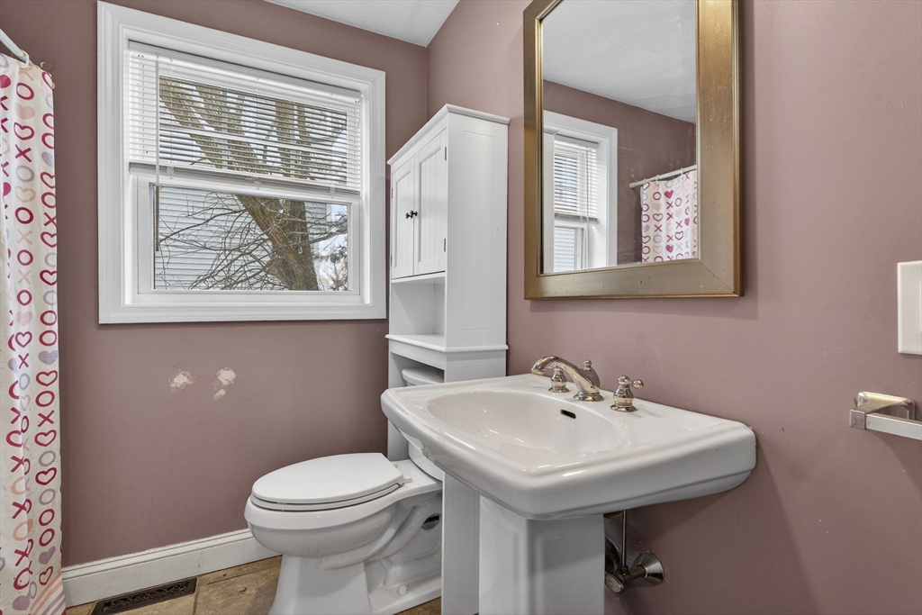 74 Linwood Street Lynn, MA 01905 - Photo 20 of 37 a bathroom with a sink a mirror and a toilet
