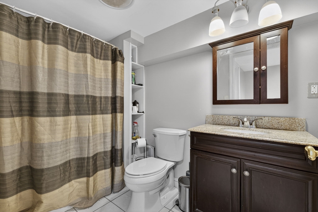 74 Linwood Street Lynn, MA 01905 - Photo 22 of 37 a bathroom with a sink a toilet and shower curtain