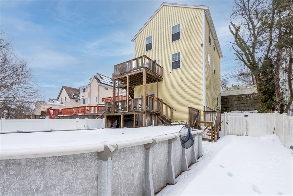 74 Linwood Street Lynn, MA 01905 - Photo 33 of 37 a view of a house with a small yard and wooden fence