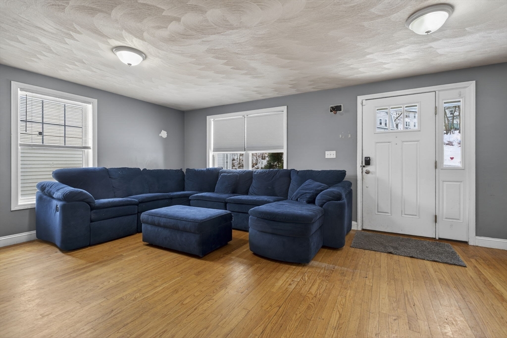 74 Linwood Street Lynn, MA 01905 - Photo 9 of 37 a living room with couches and kitchen view with wooden floor