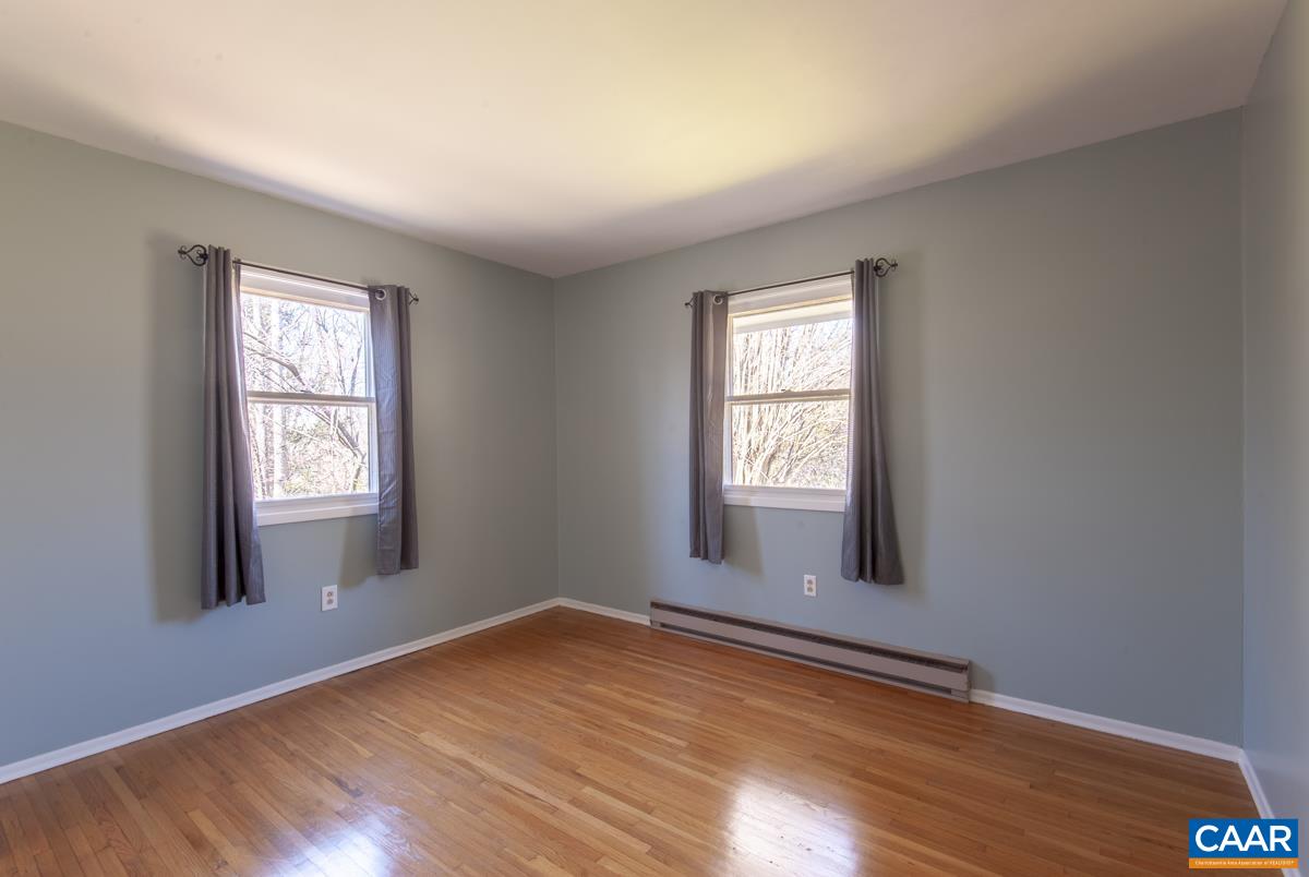 801 Poplar Spring Road Scottsville, VA 24590 - Photo 13 of 44 an empty room with wooden floor and windows
