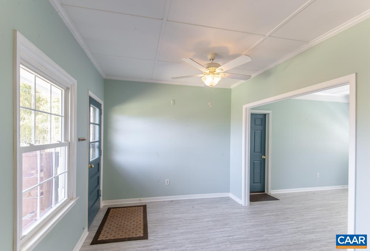 801 Poplar Spring Road Scottsville, VA 24590 - Photo 17 of 44 an empty room with wooden floor and windows