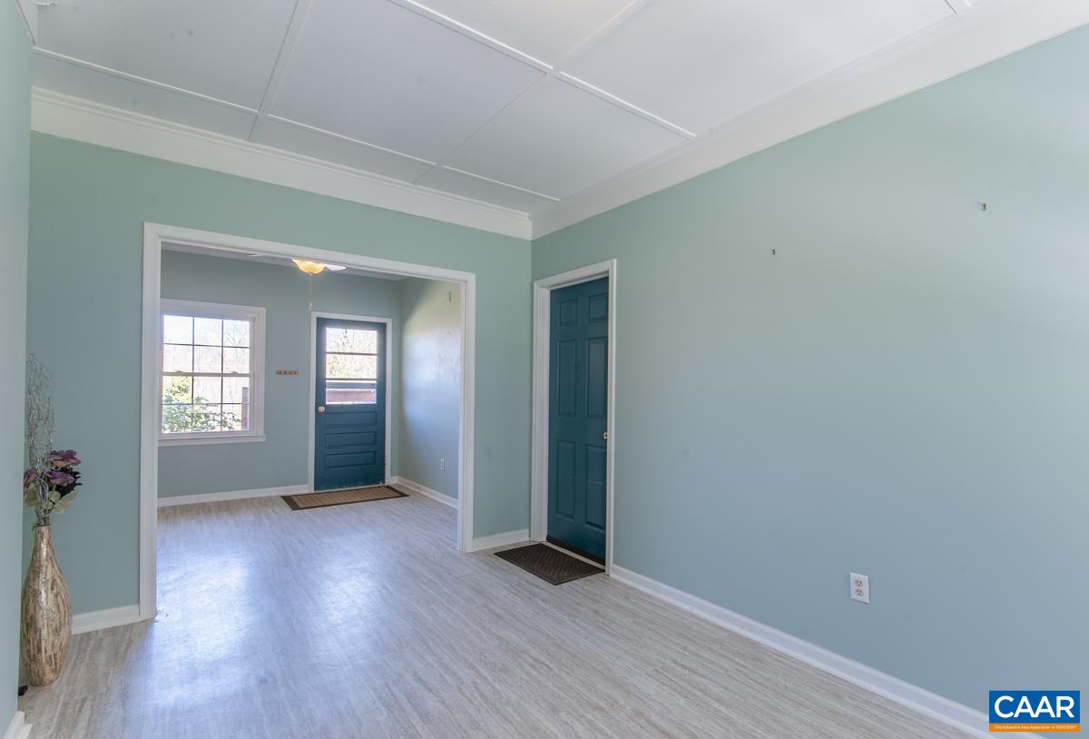 801 Poplar Spring Road Scottsville, VA 24590 - Photo 18 of 44 an empty room with wooden floor and windows