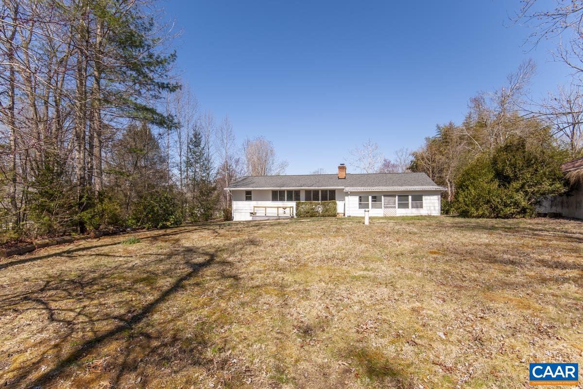801 Poplar Spring Road Scottsville, VA 24590 - Photo 34 of 44 a front view of a house with a garden and trees