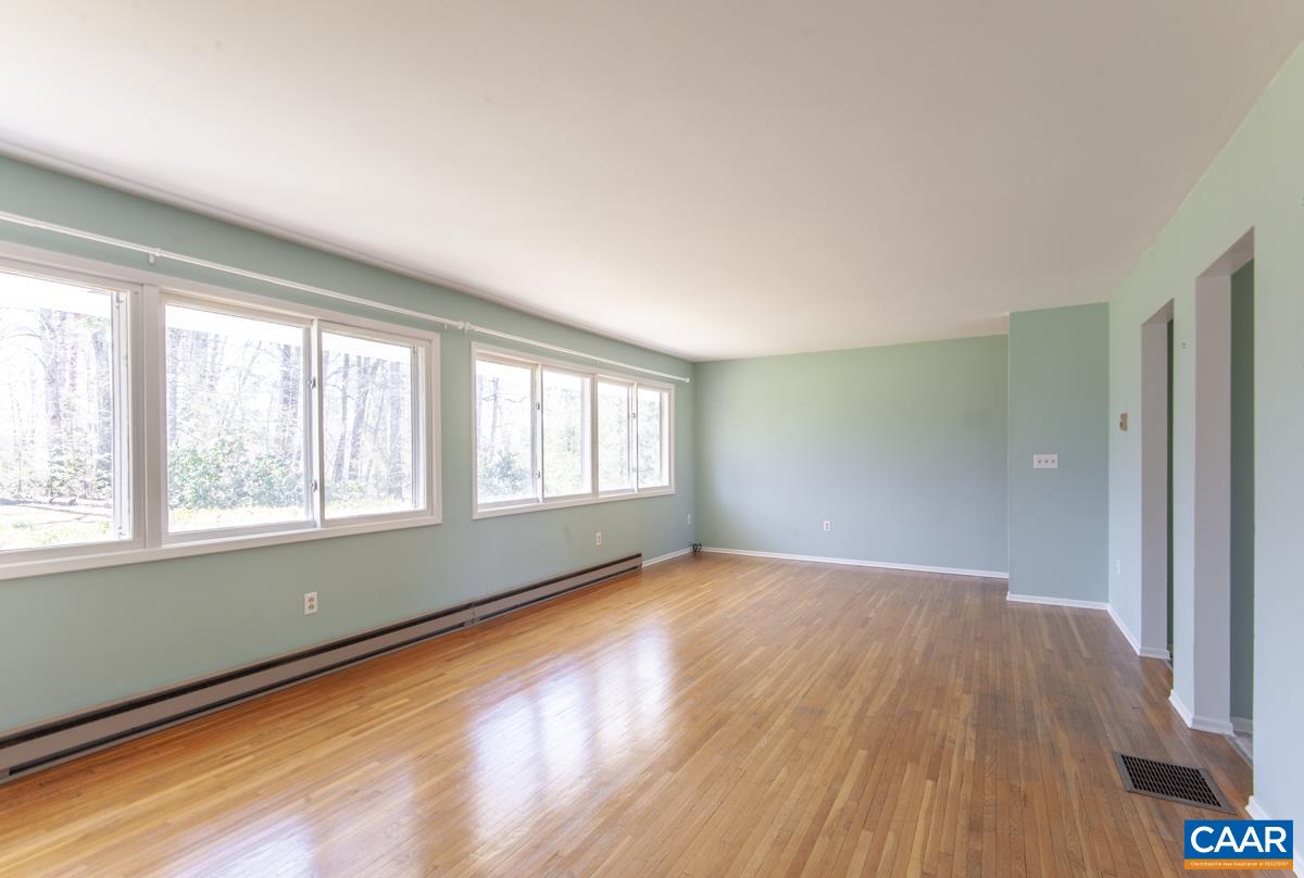 801 Poplar Spring Road Scottsville, VA 24590 - Photo 5 of 44 a view of an empty room with wooden floor and a window