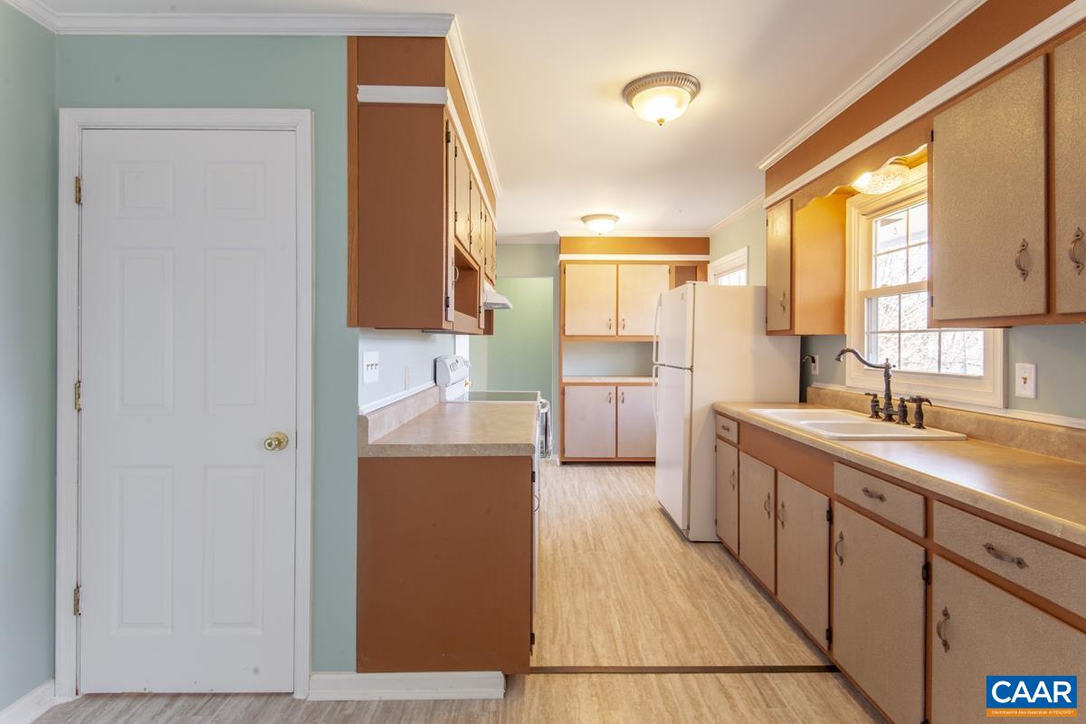 801 Poplar Spring Road Scottsville, VA 24590 - Photo 7 of 44 a kitchen with sink cabinets and window