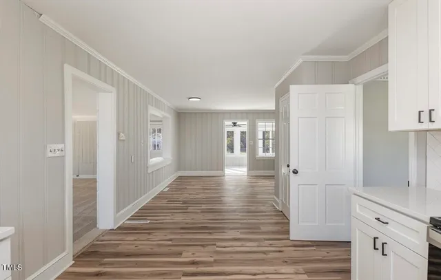 a view of a hallway with wooden floor