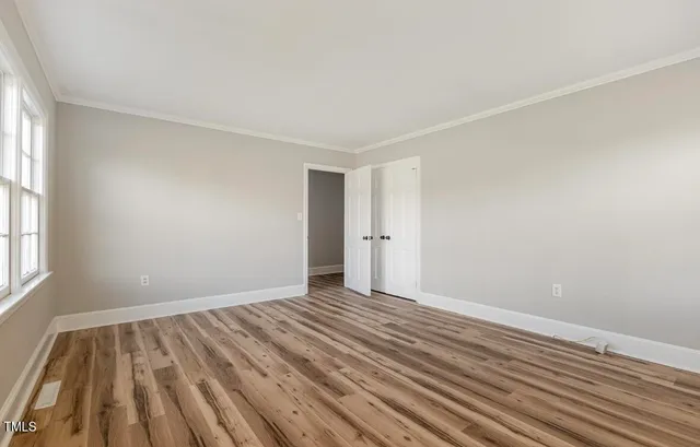 a view of room with window and hardwood floor
