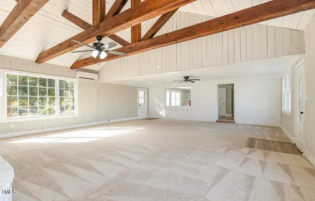 a view of a livingroom with a ceiling fan and window