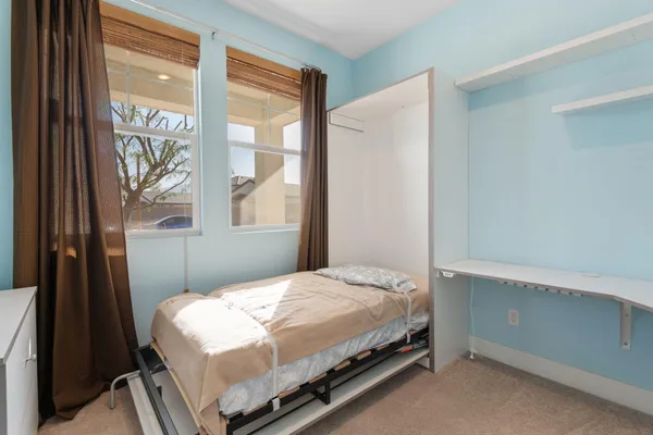 a bedroom with a bed and a window