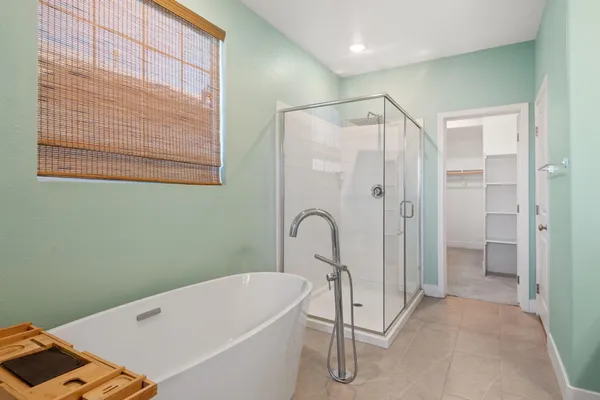 a bathroom with a bathtub and a shower