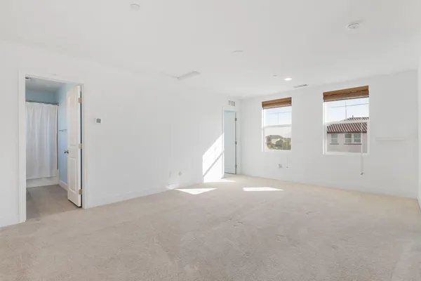 an empty room with windows and closet