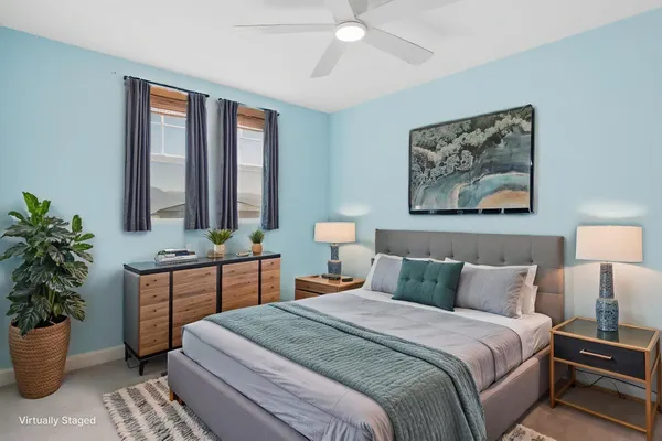 a bedroom with a large bed and a potted plant