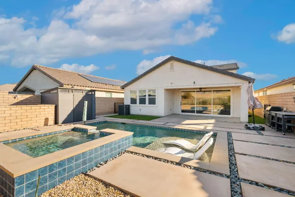 a view of a house with backyard and sitting area