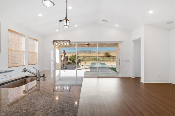 a view of a living room and kitchen with a large window