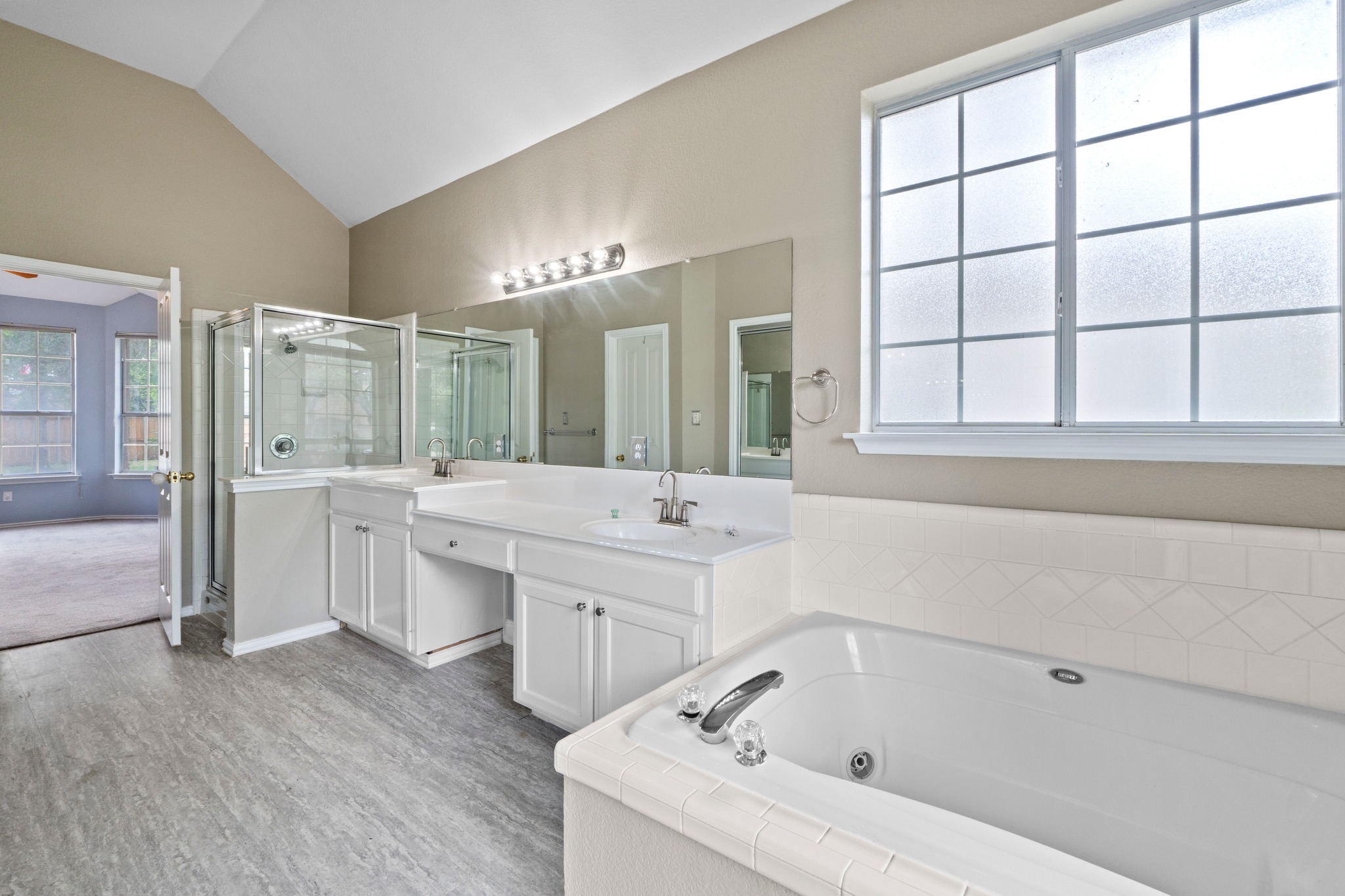 8605 Axis Drive Austin, TX 78749 - Photo 21 of 38 Indulge in a primary bathroom featuring a spacious soaking tub, dual vanity, and a separate shower.