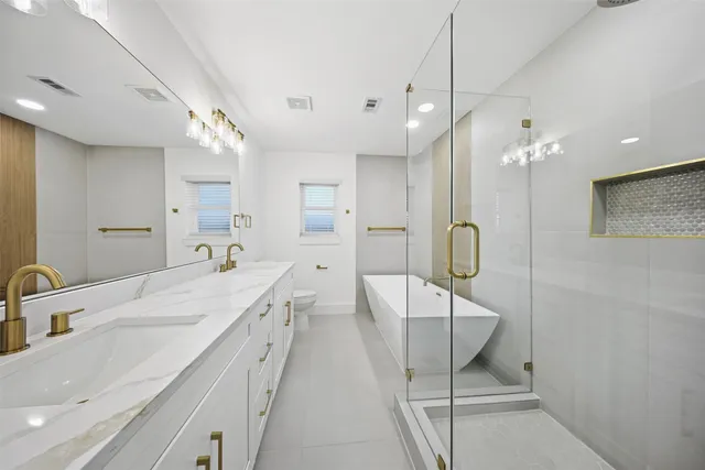 a large bathroom with a double vanity sink a large mirror and shower