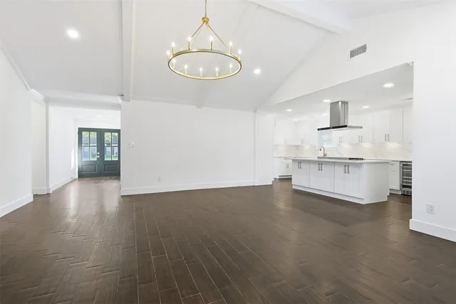 a view of a kitchen with a sink and dishwasher a refrigerator with wooden floor