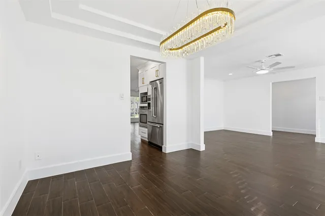 a view of a room with wooden floor and white walls