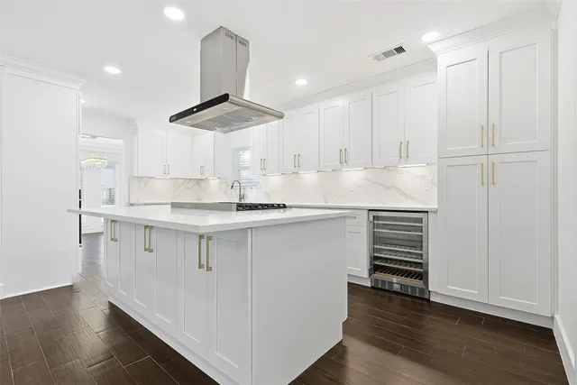 a kitchen with granite countertop a sink cabinets and stainless steel appliances
