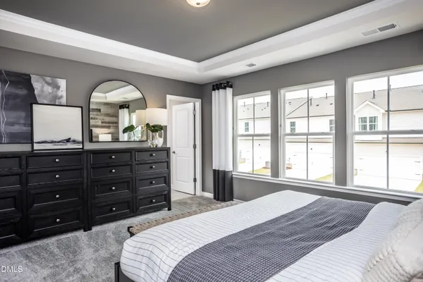 a bed sitting in a bedroom next to a window