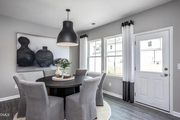 a kitchen with kitchen island a wooden floor and white cabinets