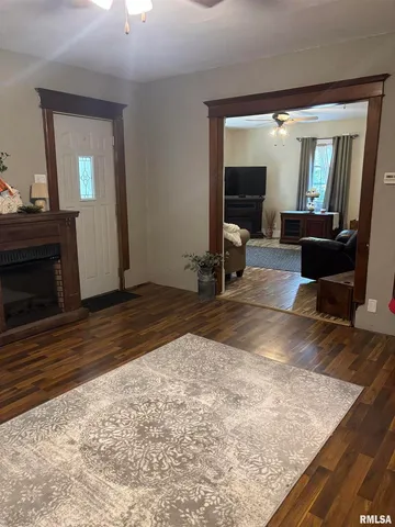 a view of a livingroom with wooden floor and furniture
