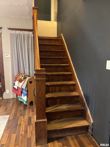 a kitchen with granite countertop a sink a stove and cabinets