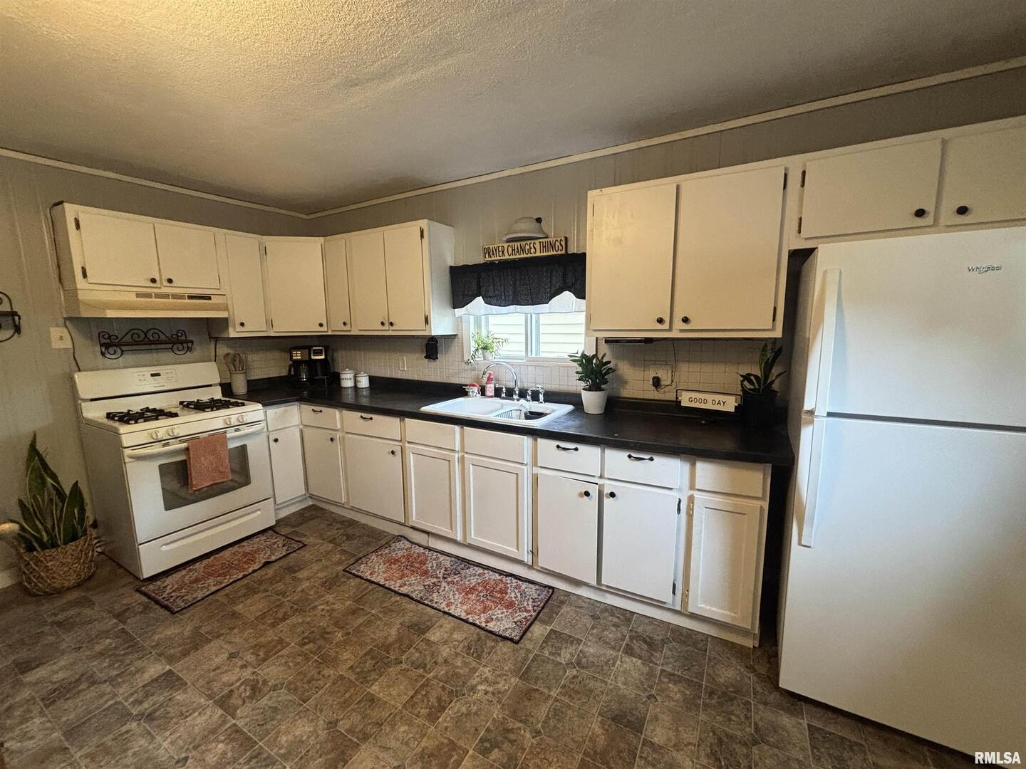 417 Northeast 2nd Avenue Galva, IL 61434 - Photo 32 of 62 a kitchen with granite countertop white cabinets and white appliances