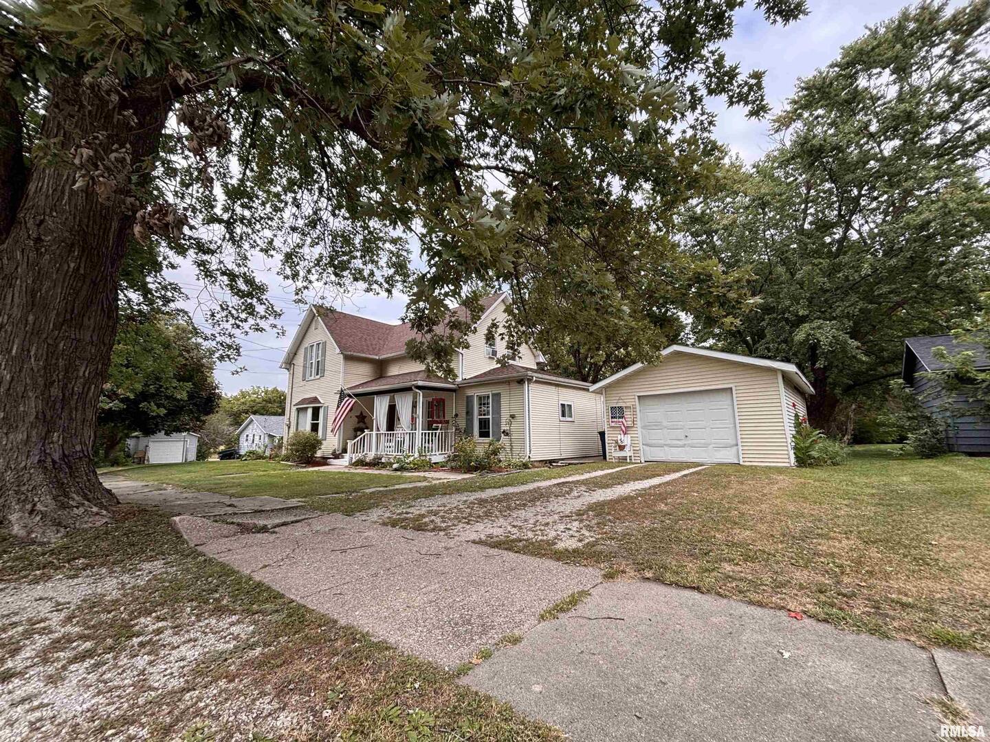 417 Northeast 2nd Avenue Galva, IL 61434 - Photo 4 of 62 a front view of a house with a yard and large trees