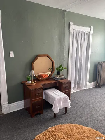a bedroom with a bed and a potted plant