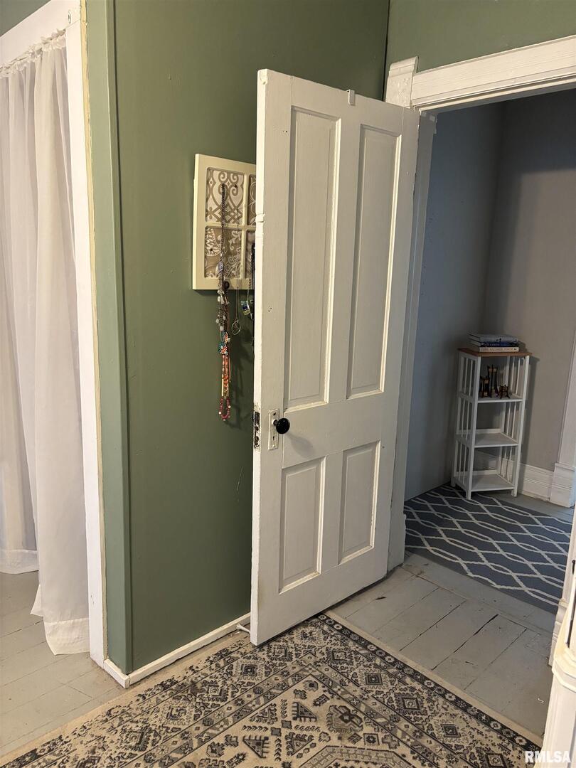 417 Northeast 2nd Avenue Galva, IL 61434 - Photo 50 of 62 a view of a hallway with wooden floor and a livingroom