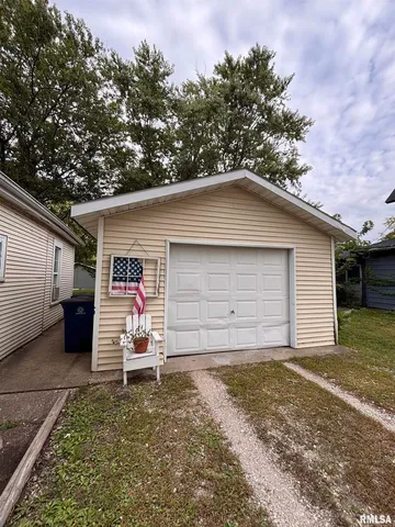 a view of a small house with a garage
