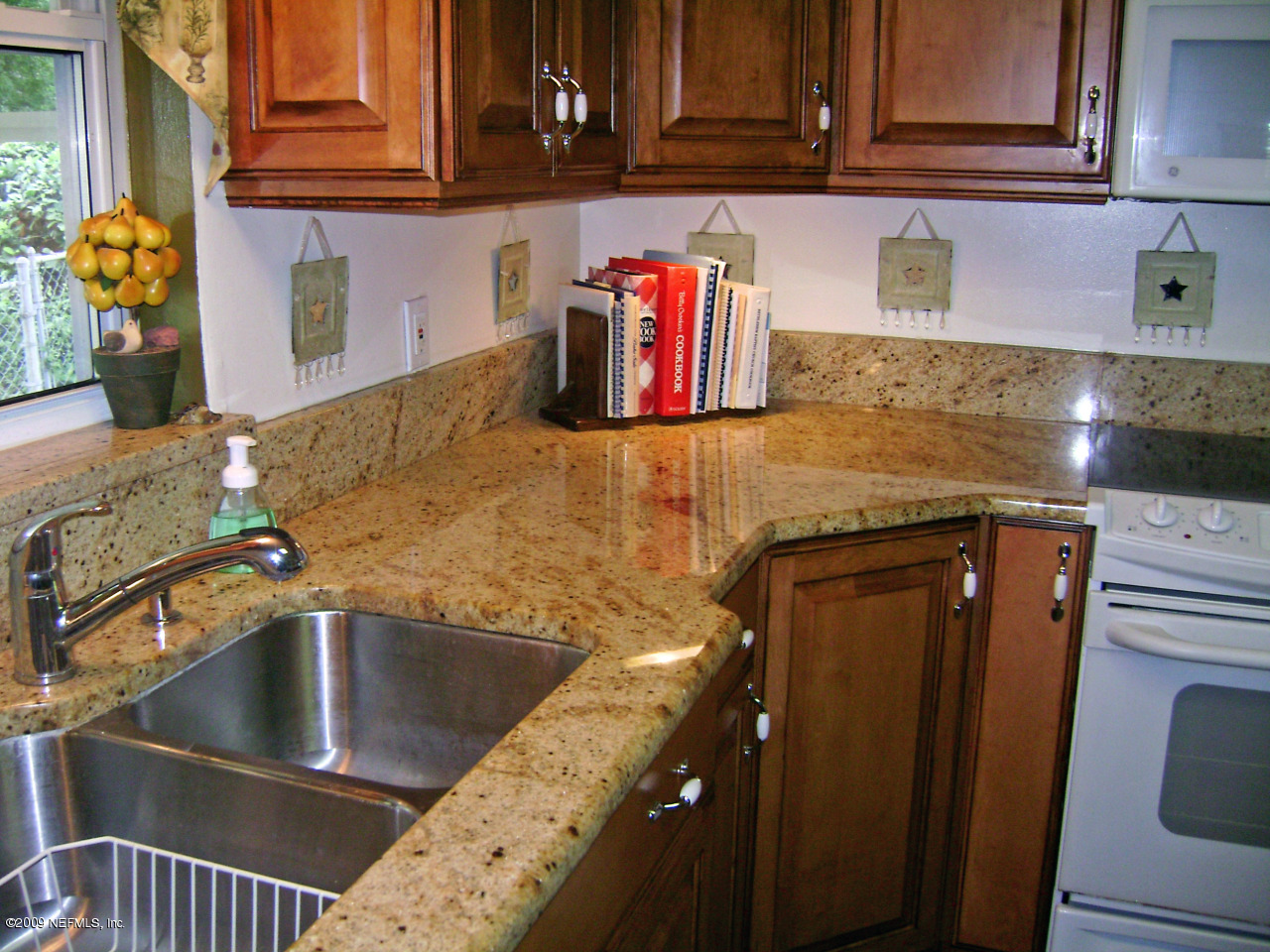 1165 Nicholson Road Jacksonville, FL 32207 - Photo 8 of 22 a kitchen with stainless steel appliances granite countertop a sink and cabinets
